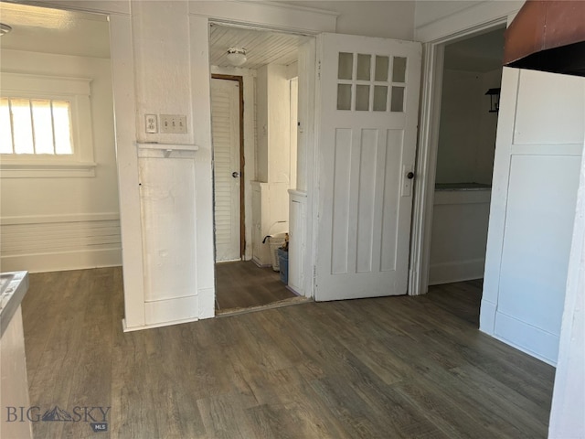 unfurnished bedroom featuring a closet and dark wood-type flooring