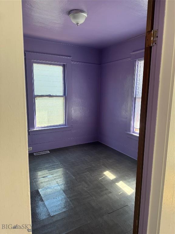 1705 Wall, Butte, MT 59701 - empty room with healthy amount of natural light and dark floors