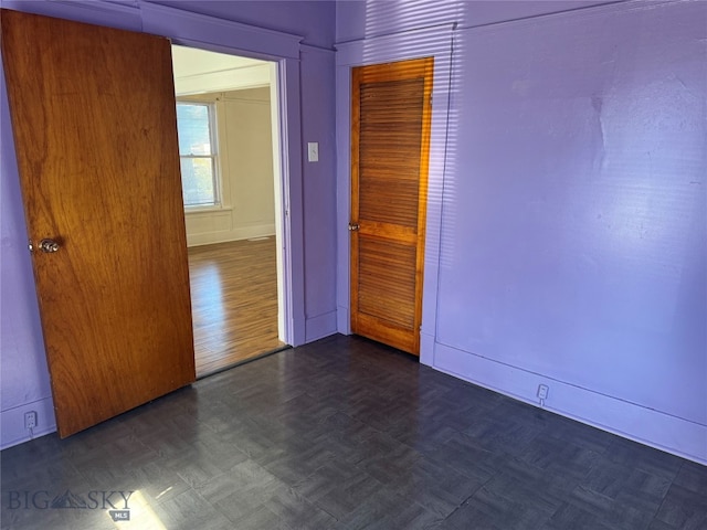 spare room featuring dark wood-type flooring