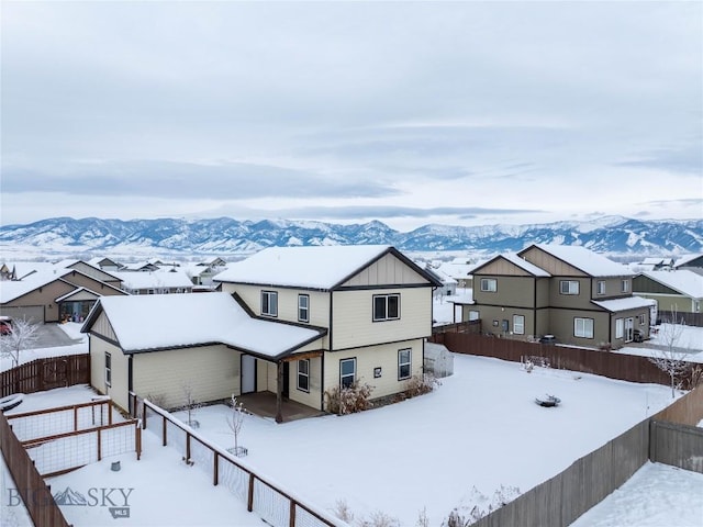 snowy aerial view featuring a mountain view