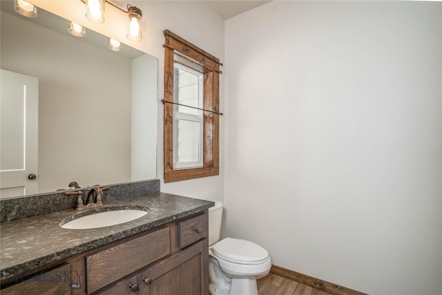 bathroom with vanity, hardwood / wood-style floors, and toilet