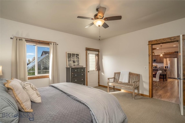 bedroom featuring carpet, stainless steel fridge, and ceiling fan