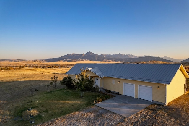 single story home with a garage and a mountain view