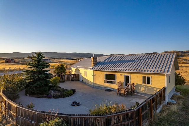 rear view of house with a mountain view and a patio area