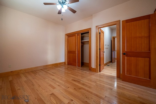 unfurnished bedroom with light hardwood / wood-style flooring, a closet, and ceiling fan