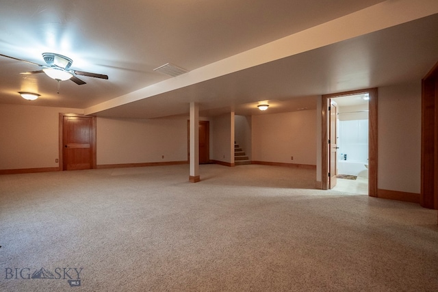 basement with light carpet and ceiling fan