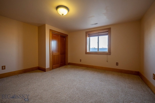 unfurnished bedroom featuring a closet and carpet flooring