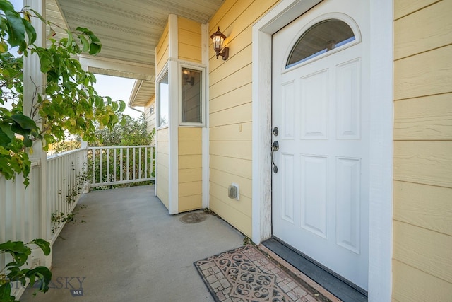 view of exterior entry with covered porch