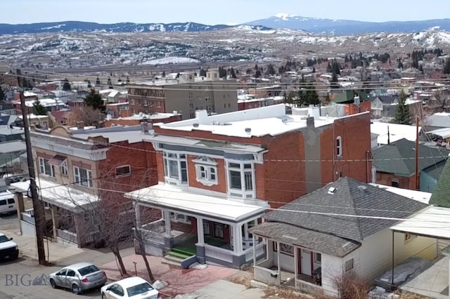 snowy aerial view with a mountain view