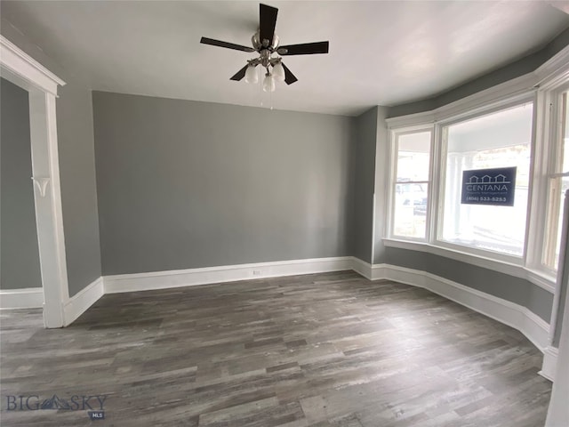 unfurnished room featuring ceiling fan and dark hardwood / wood-style flooring