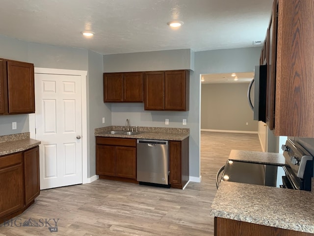 kitchen featuring sink, light wood-type flooring, and appliances with stainless steel finishes