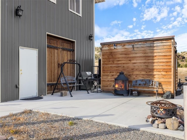 view of outdoor structure featuring a fire pit and an outbuilding