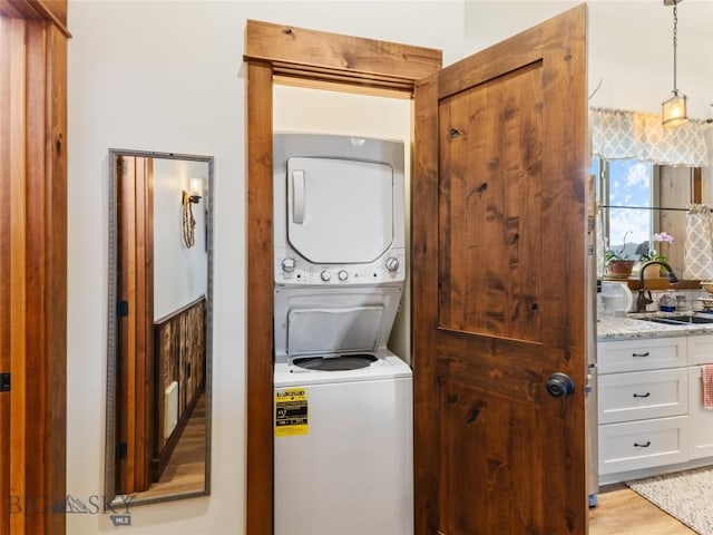 23 Caspari Way E, Emigrant, MT 59027 - laundry room with stacked washer / dryer and light wood-style floors