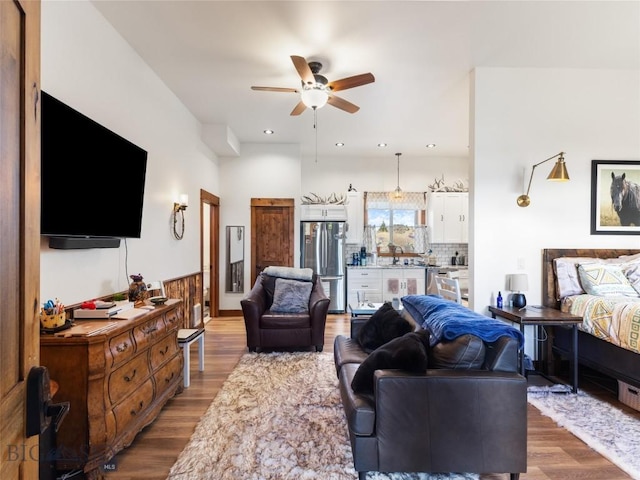 living room with ceiling fan and wood finished floors