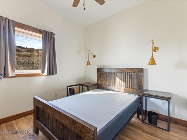 bedroom with wood finished floors, baseboards, and ceiling fan
