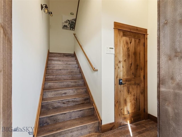 stairs featuring baseboards and wood finished floors