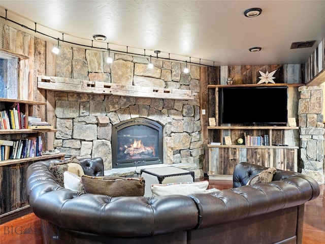 living room featuring dark hardwood / wood-style floors, a fireplace, and rail lighting