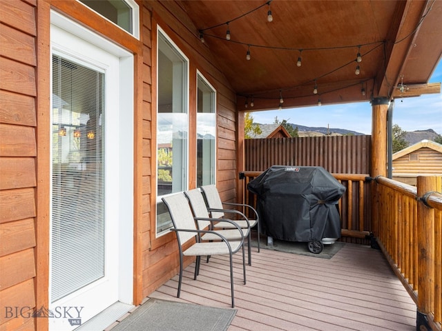 wooden terrace with a grill