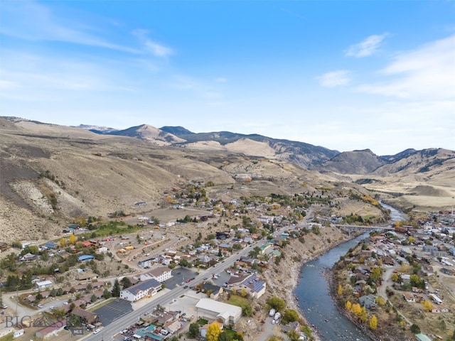 aerial view featuring a water and mountain view