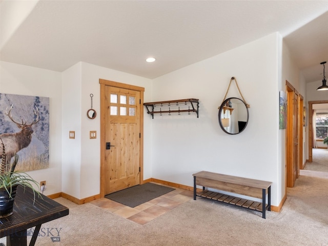 view of carpeted foyer entrance