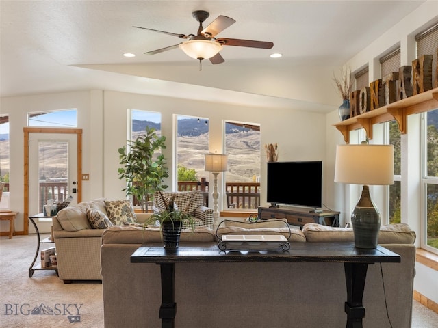 living room with light colored carpet and ceiling fan