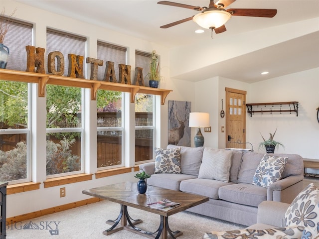 living room with ceiling fan, carpet flooring, and plenty of natural light