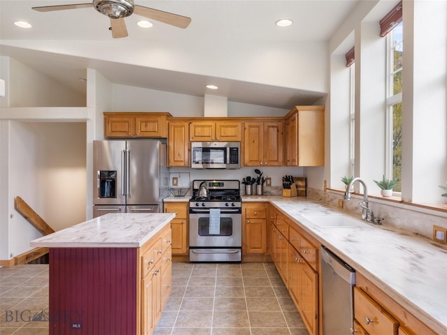 kitchen with lofted ceiling, sink, stainless steel appliances, and light tile patterned floors