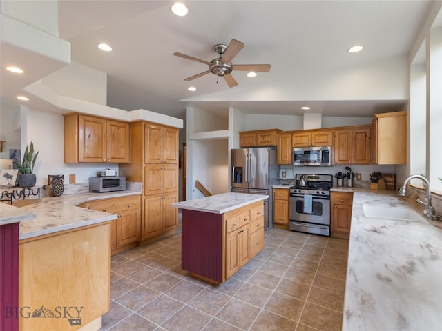 kitchen with ceiling fan, vaulted ceiling, sink, stainless steel appliances, and tile patterned flooring