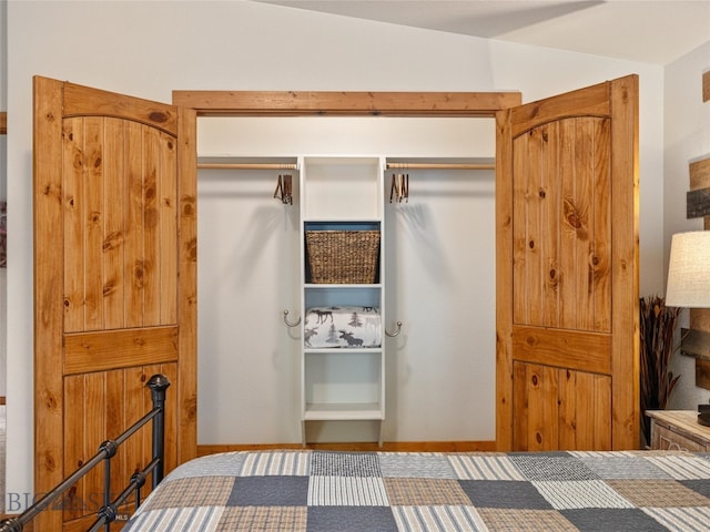 bedroom with a closet and lofted ceiling