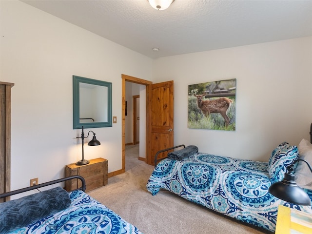 carpeted bedroom featuring a textured ceiling