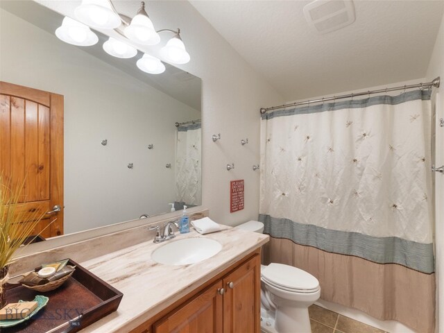 bathroom with vanity, a shower with curtain, toilet, and tile patterned flooring