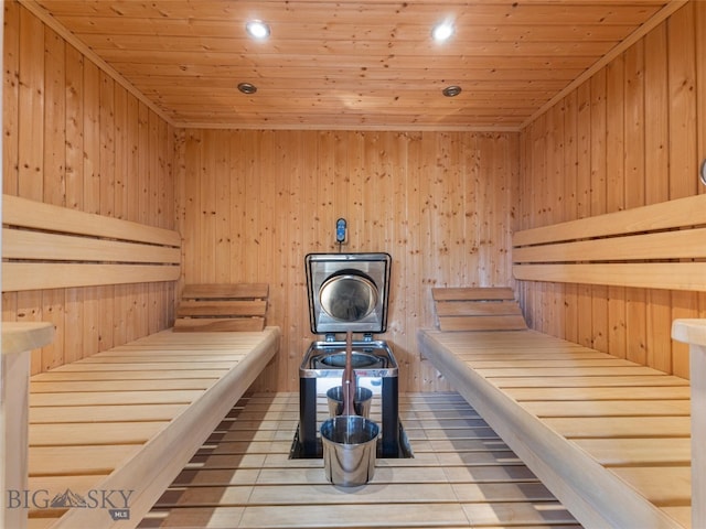 view of sauna / steam room featuring wood ceiling and wood walls