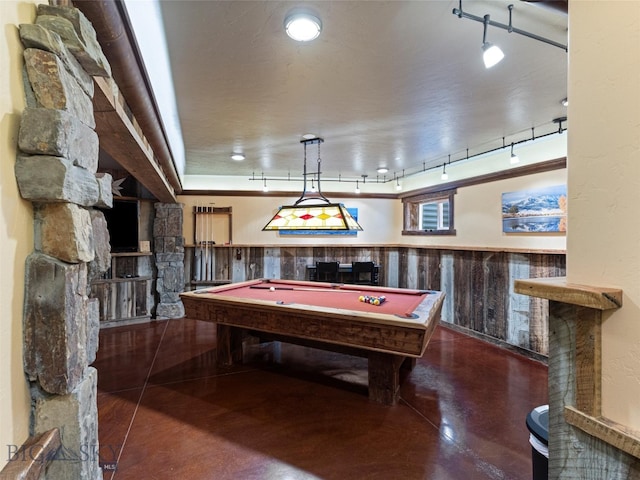 rec room featuring track lighting, pool table, and wood walls