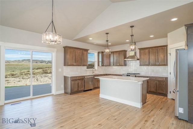 2 Smooth Brome Ct, Three Forks, MT 59752 - kitchen with appliances with stainless steel finishes, a chandelier, a sink, a center island, and light countertops