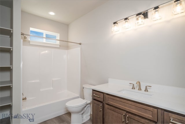 full bathroom with hardwood / wood-style flooring,  shower combination, vanity, and toilet