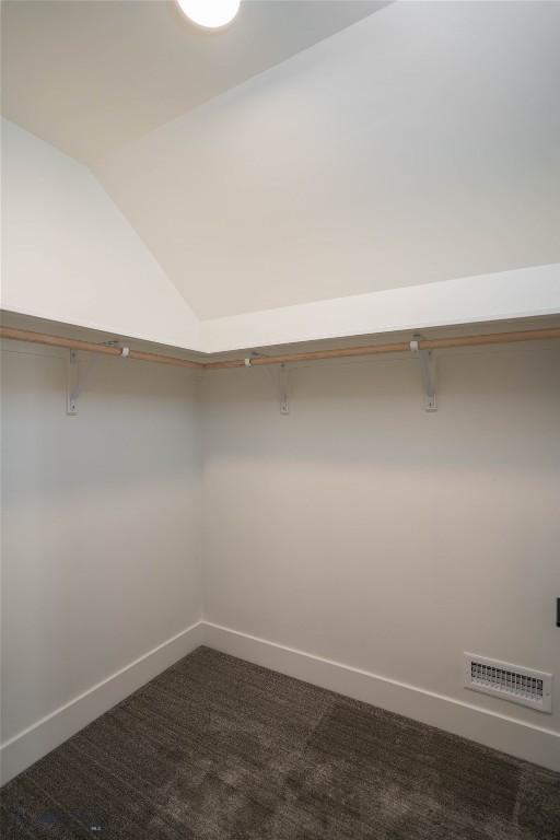 2 Smooth Brome Ct, Three Forks, MT 59752 - walk in closet with dark colored carpet and vaulted ceiling