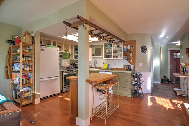 kitchen featuring wooden counters, sink, stainless steel electric range, light wood-type flooring, and white fridge