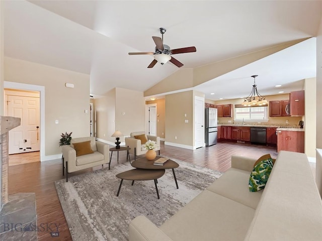 living room featuring vaulted ceiling, ceiling fan, sink, and dark hardwood / wood-style floors