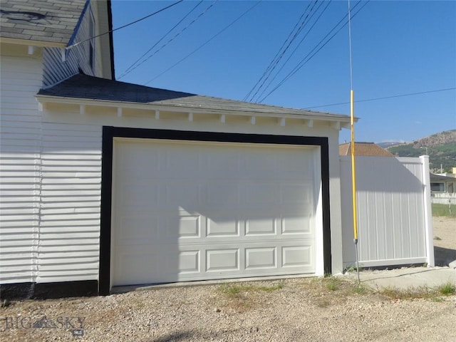 112 Washington St, Anaconda, MT 59711 - garage with dirt driveway and a mountain view