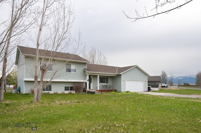 97 Ghost Canyon Ct, Belgrade, MT 59714 - tri-level home featuring concrete driveway, a garage, a front lawn, and covered porch