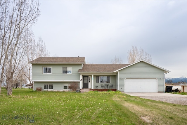 tri-level home with a front lawn and a garage