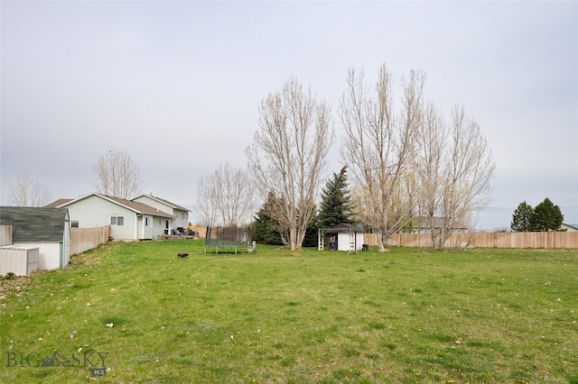 97 Ghost Canyon Ct, Belgrade, MT 59714 - view of yard featuring fence, a storage shed, an outdoor structure, and a trampoline