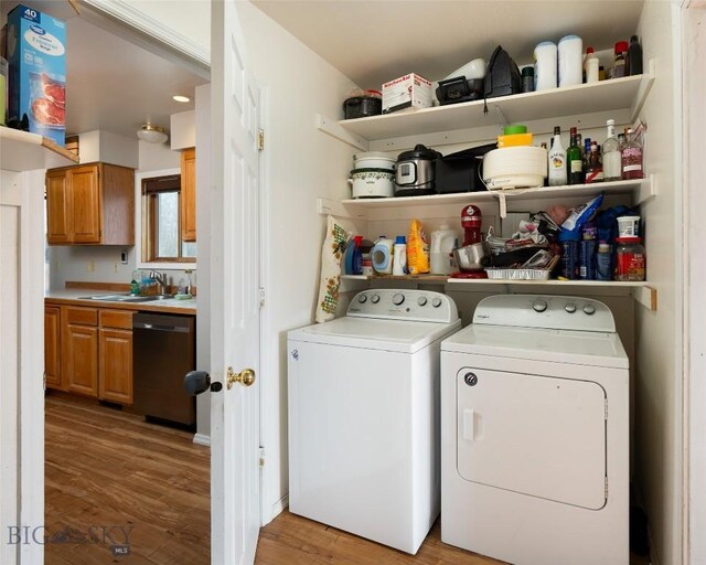 97 Ghost Canyon Ct, Belgrade, MT 59714 - clothes washing area featuring a sink, independent washer and dryer, laundry area, and light wood-type flooring
