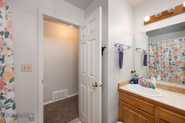 97 Ghost Canyon Ct, Belgrade, MT 59714 - full bath featuring visible vents, vanity, a shower with curtain, and baseboards