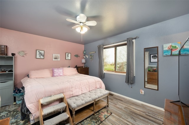 bedroom with light hardwood / wood-style floors and ceiling fan