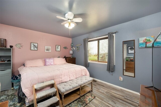 97 Ghost Canyon Ct, Belgrade, MT 59714 - bedroom with wood finished floors, ceiling fan, and baseboards
