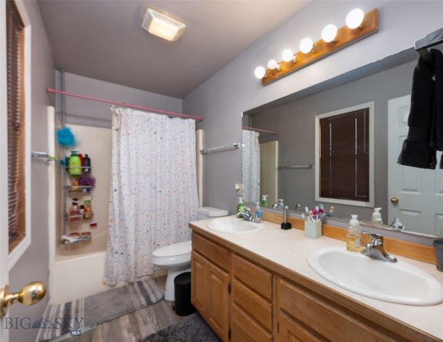 full bathroom with vanity, toilet, shower / bath combo with shower curtain, and hardwood / wood-style floors