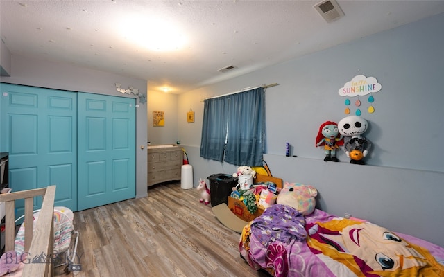 bedroom featuring a closet and light hardwood / wood-style floors