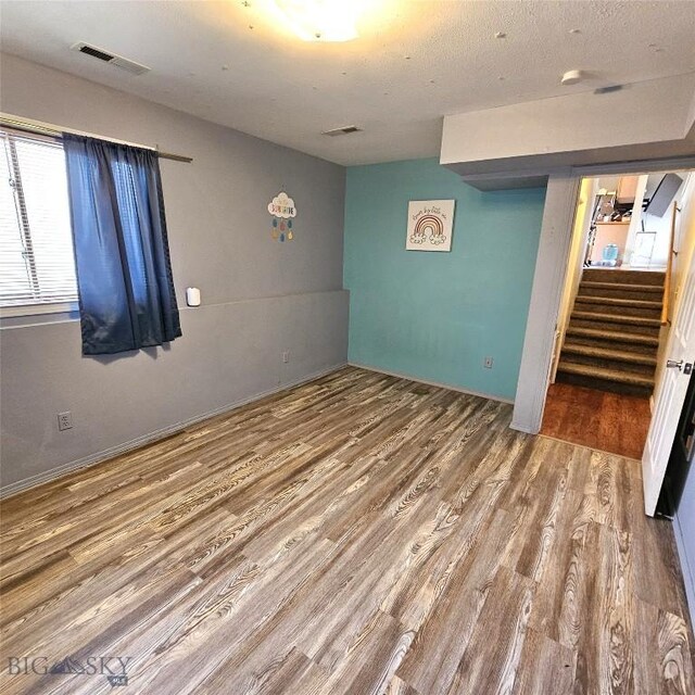 97 Ghost Canyon Ct, Belgrade, MT 59714 - interior space featuring visible vents, stairway, and wood finished floors