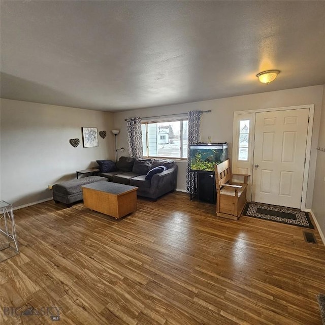 97 Ghost Canyon Ct, Belgrade, MT 59714 - living area with visible vents, wood finished floors, and baseboards